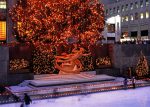 Ice rink and Prometheus statue in the Rockefeller Plaza at Christmas, New York, USA.